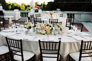 Oval Wedding linens in an outdoor reception with flowers