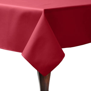 Dinner table dressed with an elegant holiday red tablecloth
