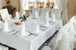White Cotton Twill tablecloths layered on a luxurious reception table with place settings & napkins