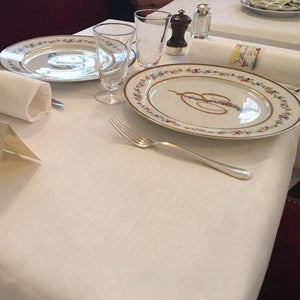 Elegant Twill linens on a table at an upscale restaurant with monogrammed china