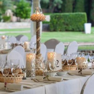 Fine Linens in an elegant outdoor wedding reception with napkins candles and plates