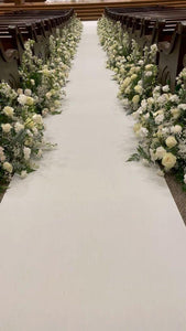 Velvet Wedding aisle runner in white with flowers on each side leading to altar