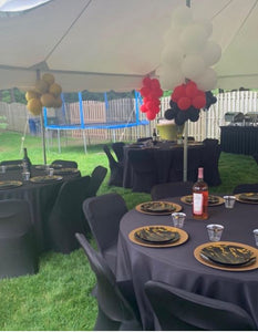 black 120 round tablecloths at an event under a tent