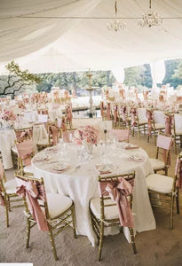 Luxury outdoor wedding with poly table lines under a tent