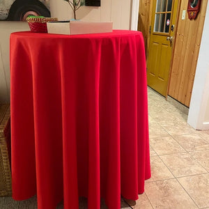 Holiday Red round tablecloth on a cocktail table