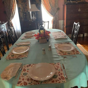 Large oval tablecloth with placemats and china