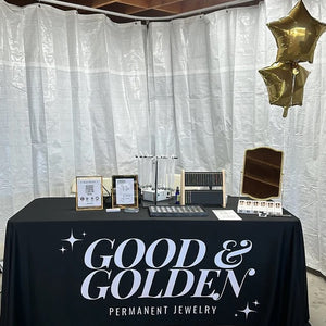 tablecloth with custom logo of a jewely store with mechandise on top of table