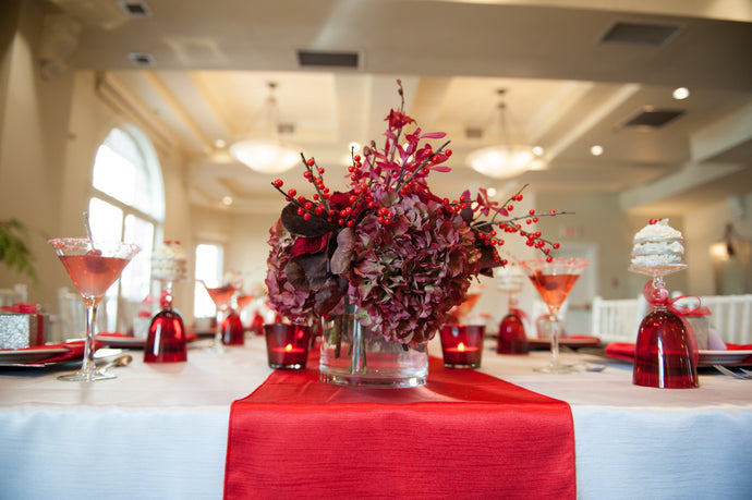 White majestic bridal linens and matching red table runner