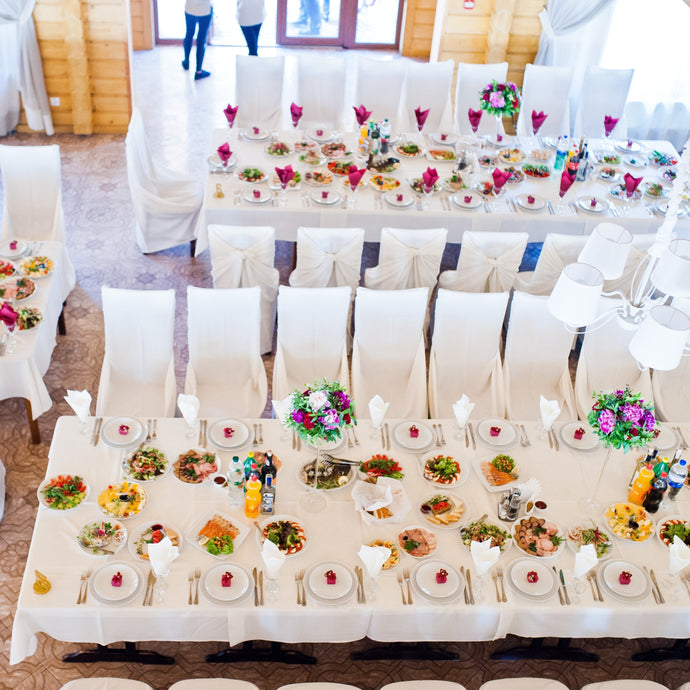 Poly premier tablecloths with matching chair covers in a barn-style dinner 