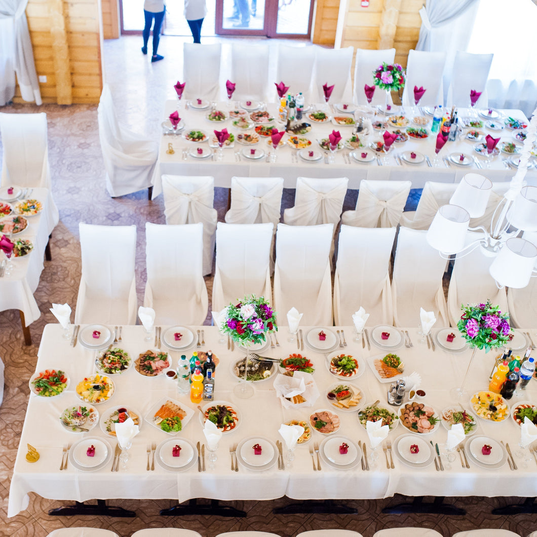 Poly premier tablecloths with matching chair covers in a barn-style dinner 