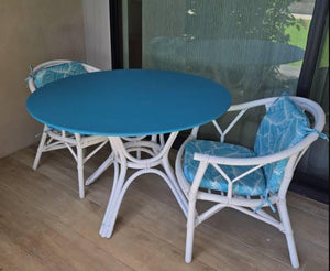 blue round vinyl fitted tablecloth on a white table on a porch