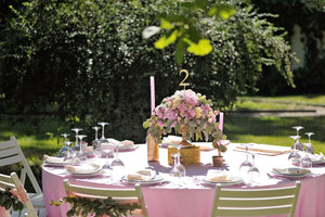 Pink Bridal linens with table number and flower centerpiece