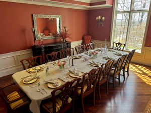 English linen tablecloth on a very large wooden table with placmats and deorated napkins