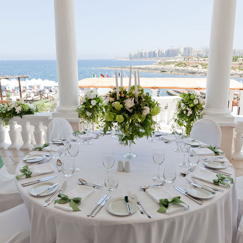 White round table linens during a luxury reception with a view of the ocean