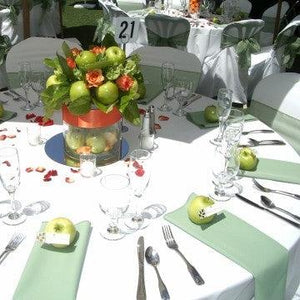 Havana white linens on round tables with beige napkins and apples on top