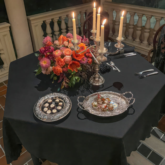 Hexagon table tablecloth on a porch, romatic table setting with china and candles.