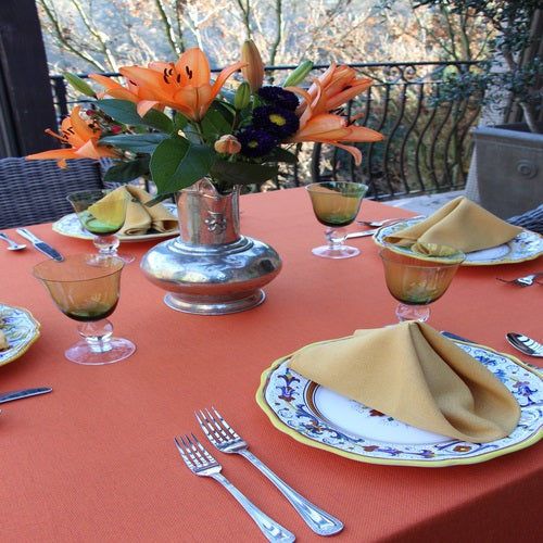 Burnt orange linens with plates and cutlery