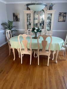 Sage green oval tablecloth in a dining room