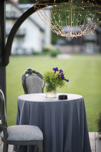 Poly Premier table linens in Wedgwood color on a round outdoor lunch table