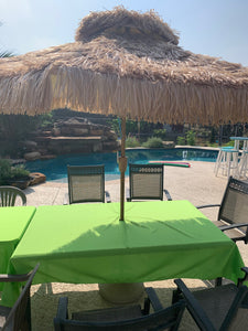 Poly premier tablecloth on table with tiki hut style umbrella