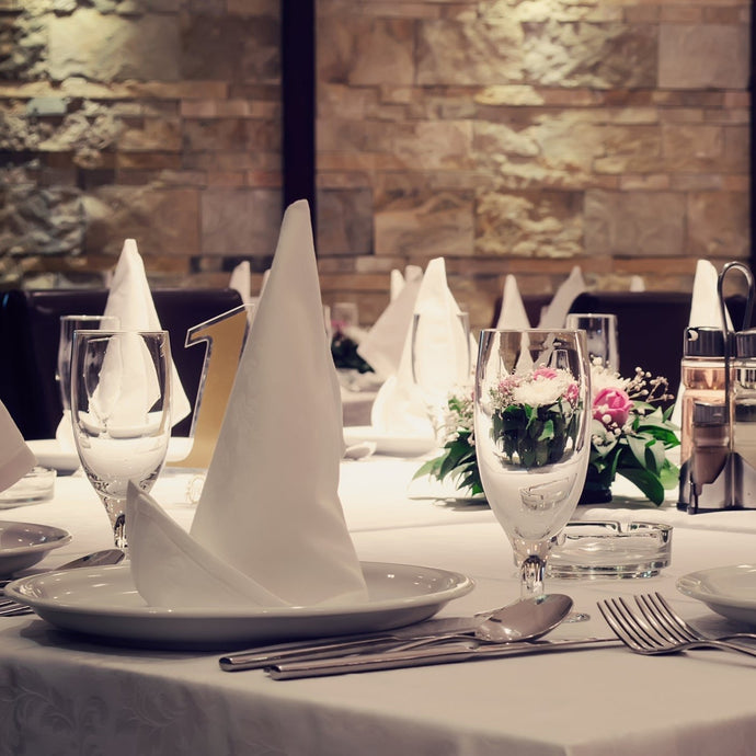 Quality Spun poly napkins folded to stand on dishes