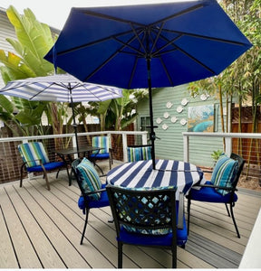 Waterproof outdoor tablecloth with umbrella hole and zipper on a patio