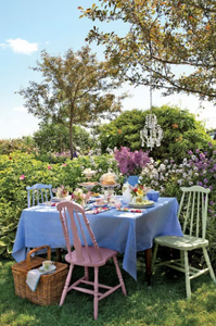 Blue sqaure tablecloth, table set in  beautiful garden