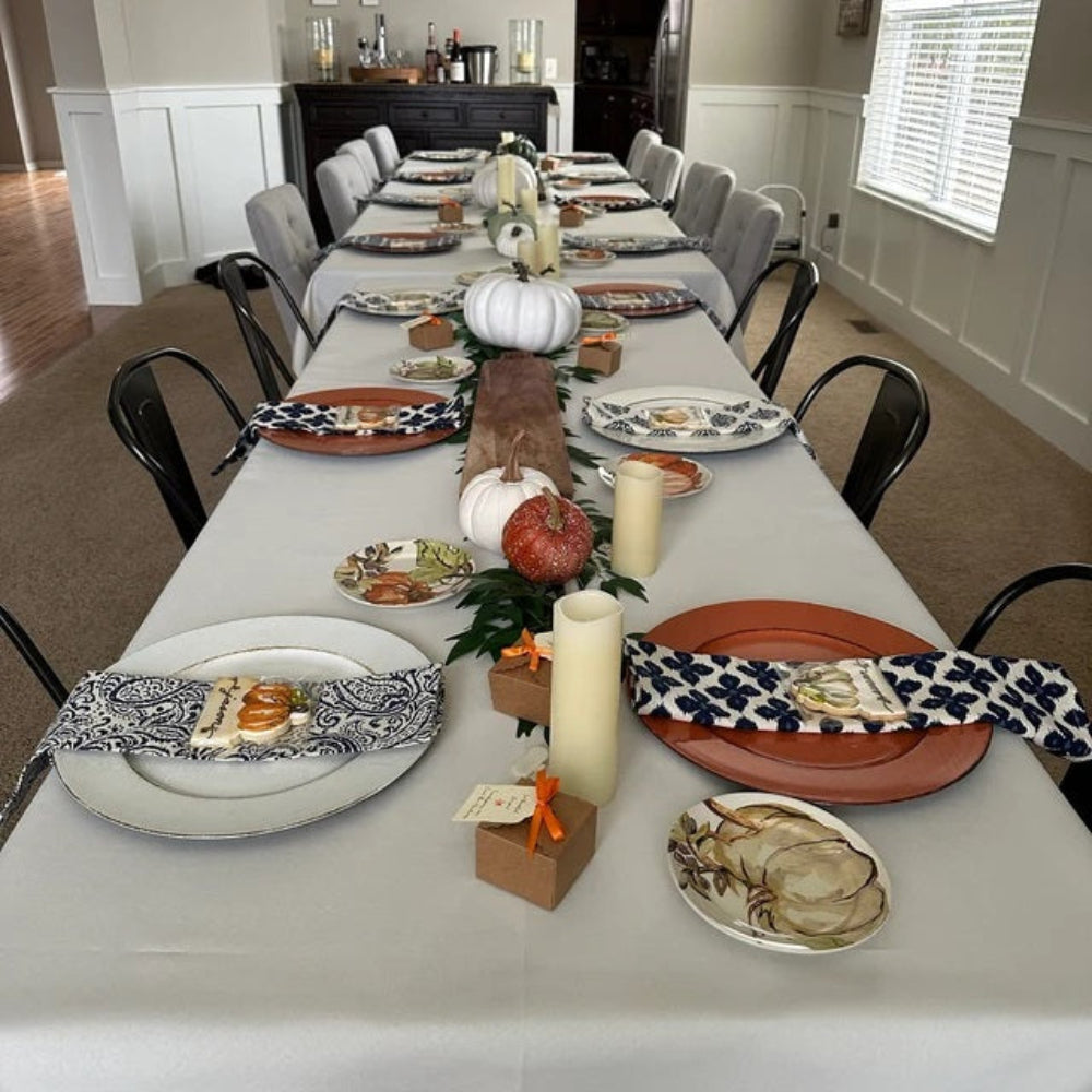 Rectangular tablecloths on one very large table set for Thanksgiving.