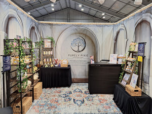 Trade show booth with blank tablecloths and products on display