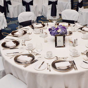 120 Round Tablecloth at a reception with place settings and napkins