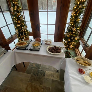 Corporate Chistmas party with white blank table cloths and holiday goods. 