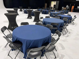 Bland tablecloths, blue at a convention being setup.