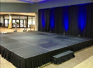 Stage with back drop and black stage skirt at a mall