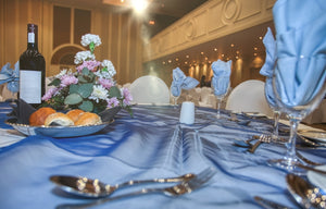 Blue bridal linens at a wedding reception with bread on the table