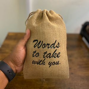 Custom-printed burlap bag being held by a person with black text