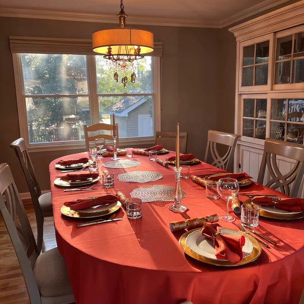 Polyester burnt orange tablecloth and napkins on a formal table during Thanksgiving
