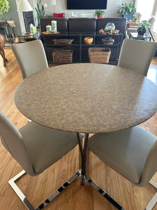 round vinl fitted tablecloth on a table in a living room.