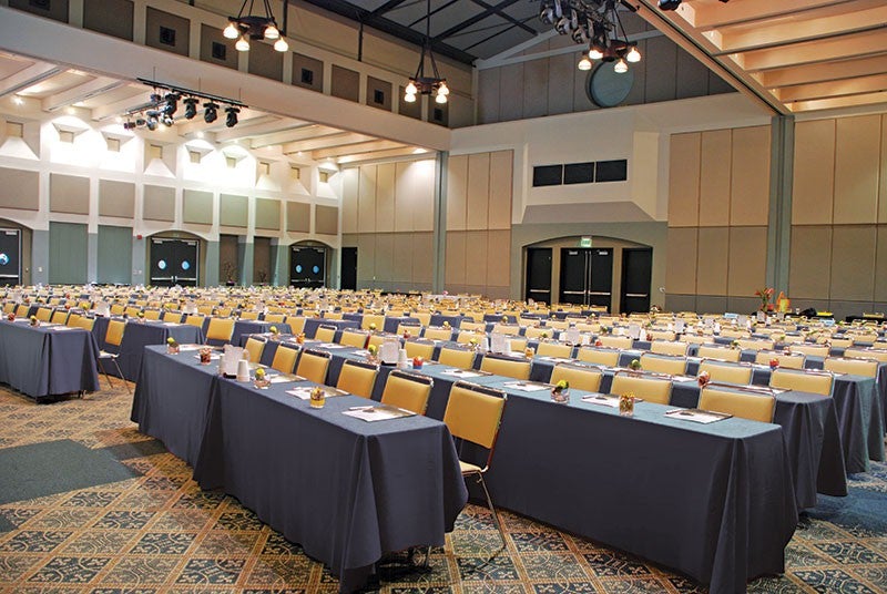 Large meeting area with many tables featuring our Spun Poly tablecloths