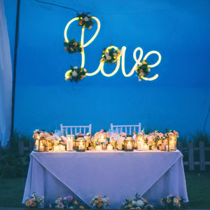 Head table with tablecloth and overlay at wedding reception