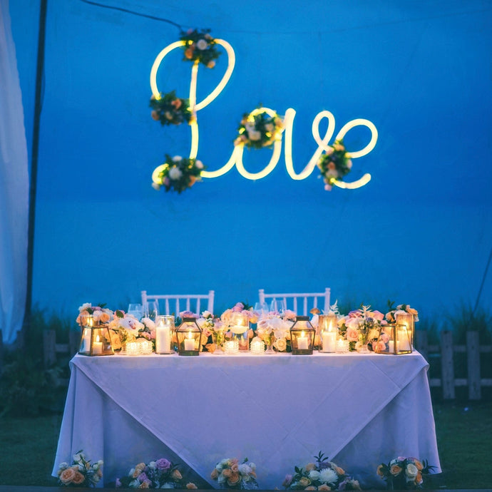 Head table with tablecloth and overlay at wedding reception