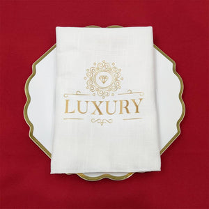 Luxury napkin with one color gold print folded flat on plate
