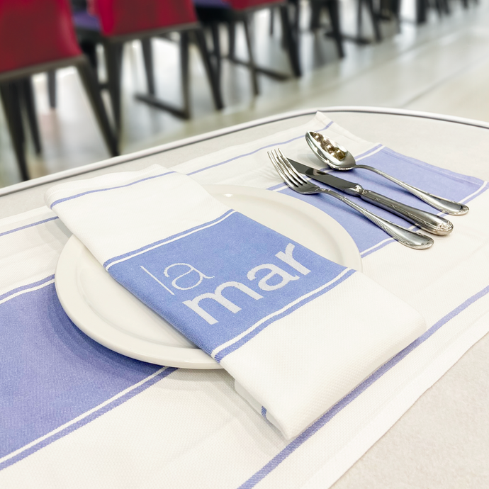 White and blue Custom printed napkins with plates and cutlery at a restaurant