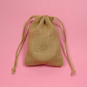 Blank Burlap Baggie in front of a pink background