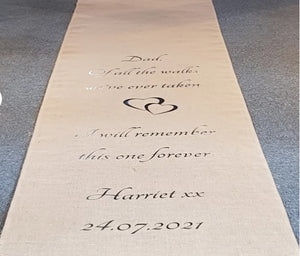 Custom-designed burlap aisle runner at a church ceremony