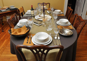 Brown oval tablecloth with goldenrod napkins