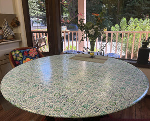 Fitted round vinyl oilcloth tablecloth on a farmhouse dining room table.