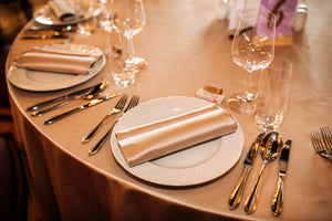 Gold Duchess tablecloth with matching napkins on plates