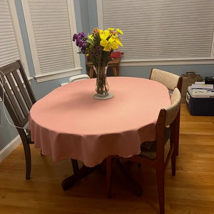 Oval linen tablecloth with vase of flowers
