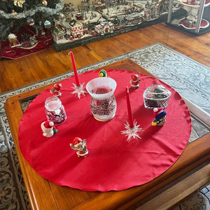 Round table Holiday cover on a coffee table with candles and Christmas trinkets
