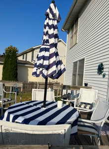 Nautical outdoor tablecloth with umbrella hole and zipper on a outside deck